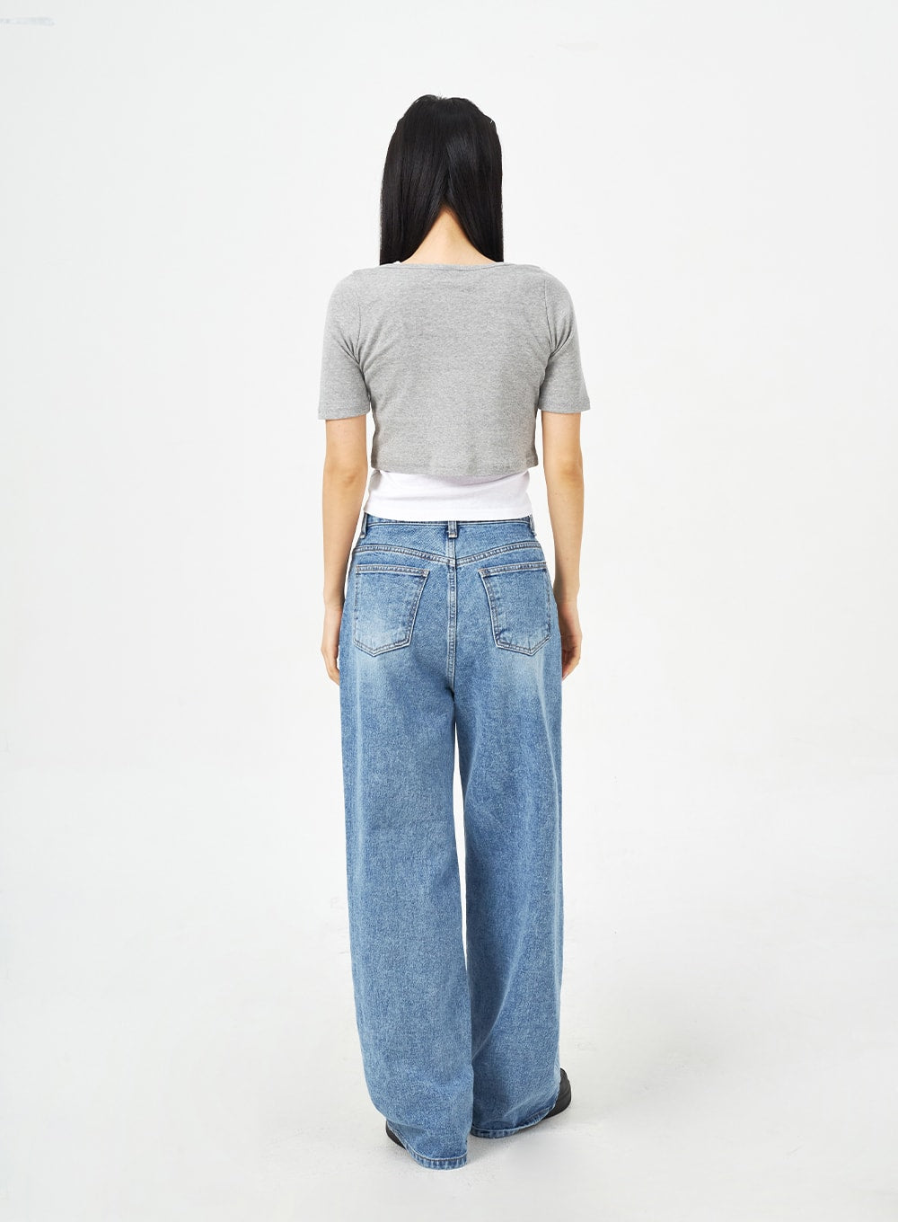 Mid-Wash Bootcut Jeans CM323 in mid blue, full back view on model, showing back patch pockets, high-rise waistband, and wide-leg washed denim with bootcut flare at hem.