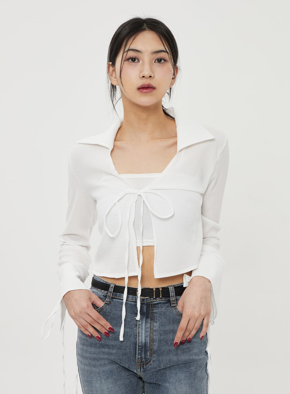 Straight Leg Ankle Jeans BF316 in mid-blue wash, upper-body close-up on model, showing high-rise waistband and belt detail, paired with white tie-front crop top.