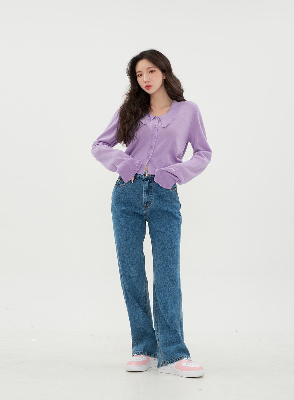 LEWKIN Semi Wide Jeans BM21 in mid-blue denim, front full-body on model standing upright, wide-leg cotton denim with zip-up closure, paired with purple cropped cardigan and pink sneakers.