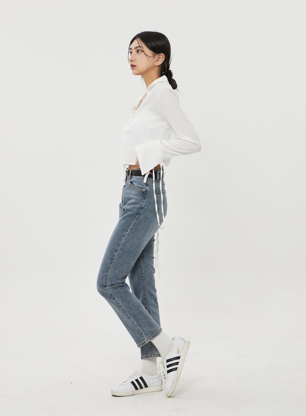 Straight Leg Ankle Jeans BF316 in mid-blue wash, side profile on model, highlighting slim straight silhouette, high waist, and cropped ankle hem, styled with white crop top and sneakers.