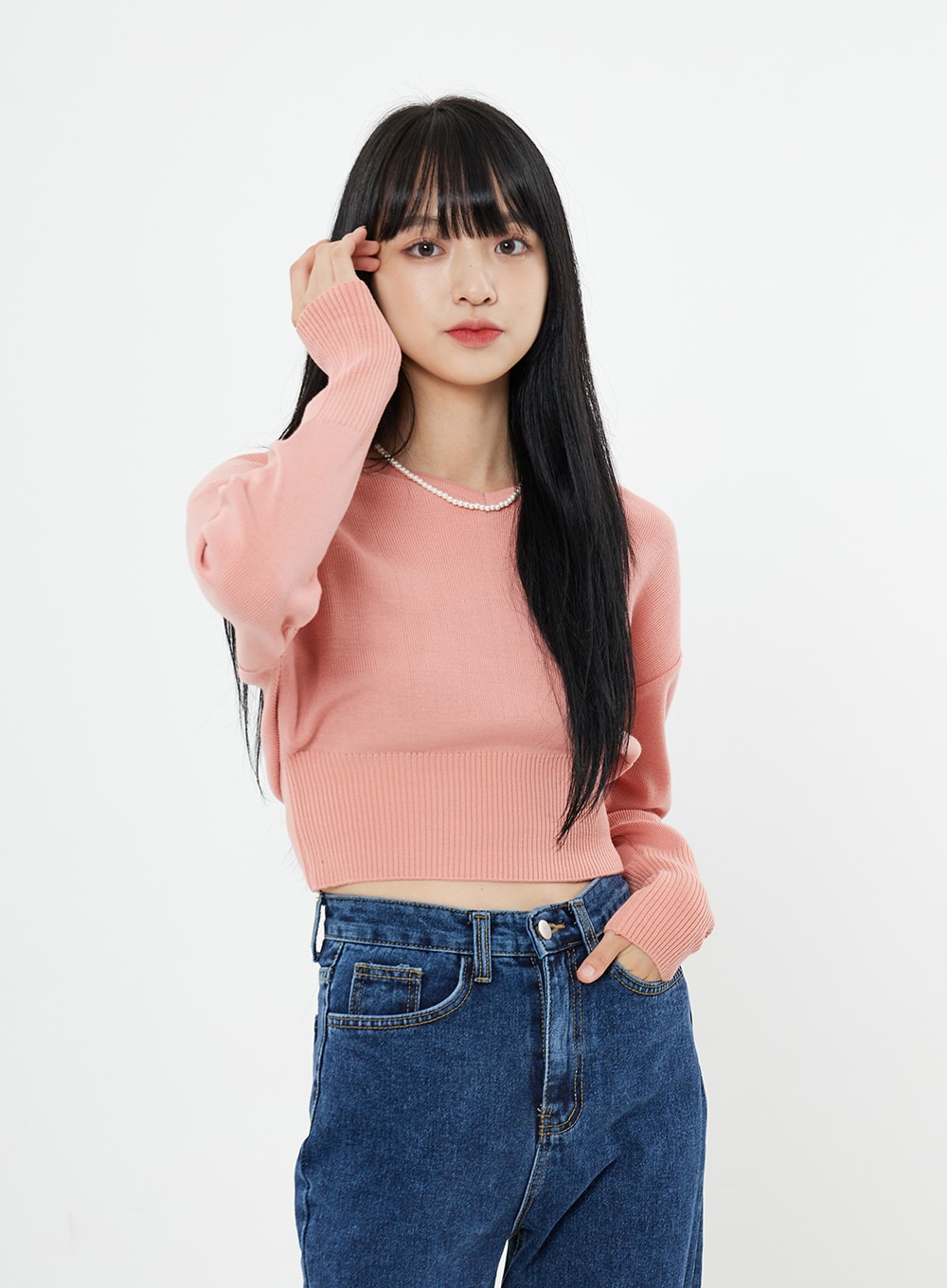 Basic Long Denim Pants BS28 in mid-blue, upper-body close-up on model showing high-rise waistband and front pockets, straight-fit cotton denim, styled with pink crop knit.