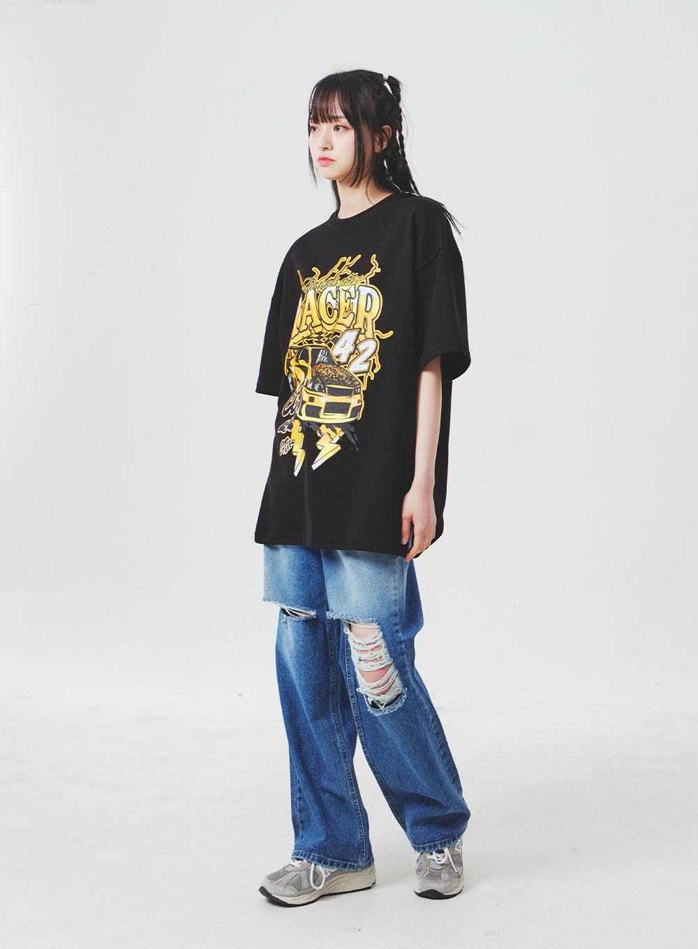 Ripped Knee Blue Jeans BA307 in blue, three-quarter side-front shot on model, wide-leg denim with prominent destroyed knee openings and vintage wash, styled with black graphic tee.