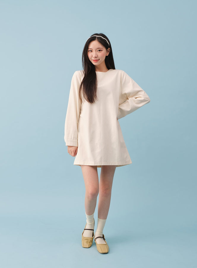 Sheer Ribbed Socks BY27 in cream, full-body front shot on model in a relaxed ivory mini dress, sheer ribbed nylon socks at crew length, styled with yellow square-toe Mary Jane flats.