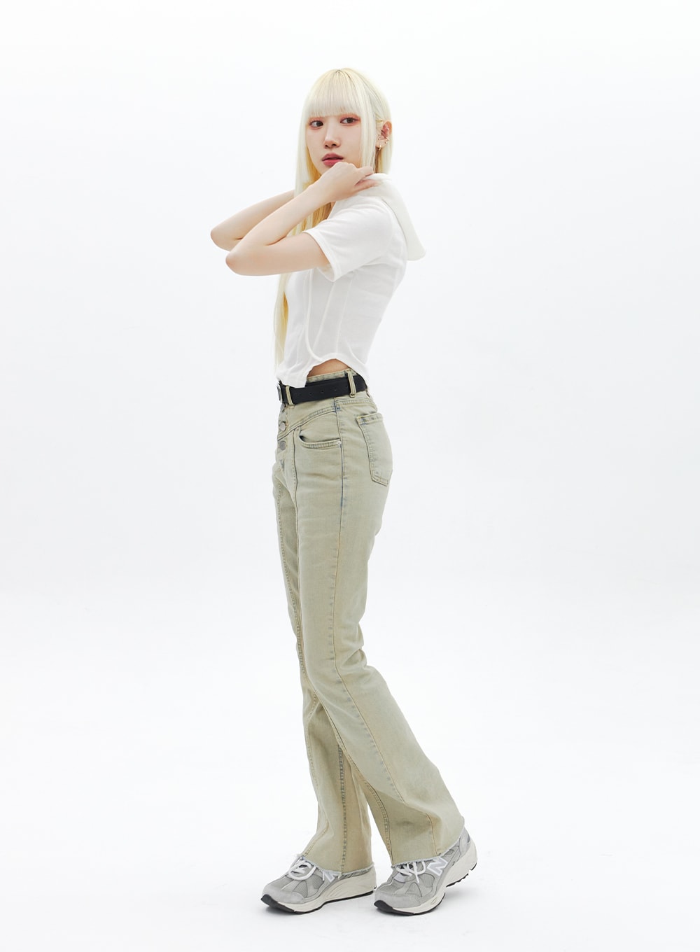 Beige Wash Bootcut Jeans BA320 in beige, full-length side view on model in dynamic pose, bootcut flare and center front seam clearly visible, paired with white tee and black belt.