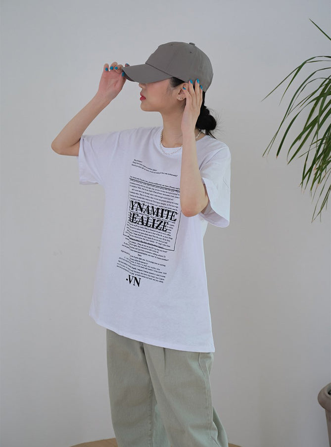 Baseball Cap with Logo Print CM03 in grey, side three-quarter view on model adjusting brim, curved bill and P logo detail visible, styled with white graphic tee and sage trousers.