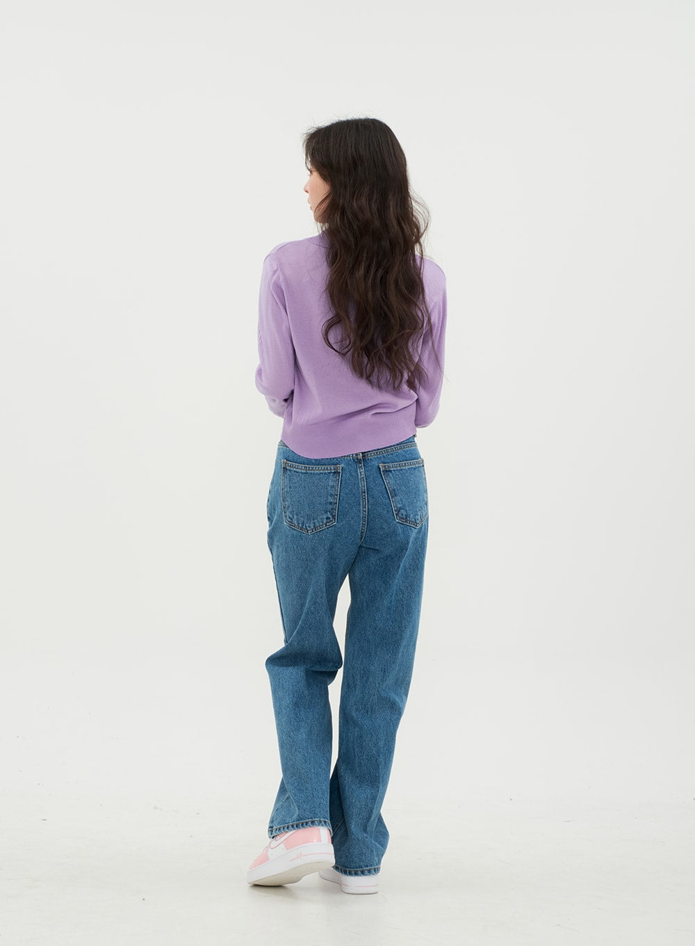 Semi Wide Jeans BM21 in mid-blue denim, back view full-body on model with slight turn, back pockets and wide-fit hem length clearly visible in solid cotton denim, styled with lavender knit.