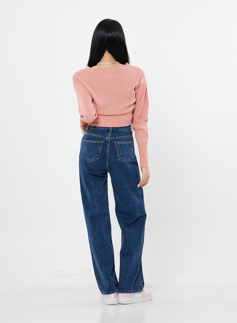 Basic Long Denim Pants BS28 in mid-blue, back full-length on model, showing dual back pockets and straight wide-leg silhouette, high-rise cotton denim, with pink crop knit.
