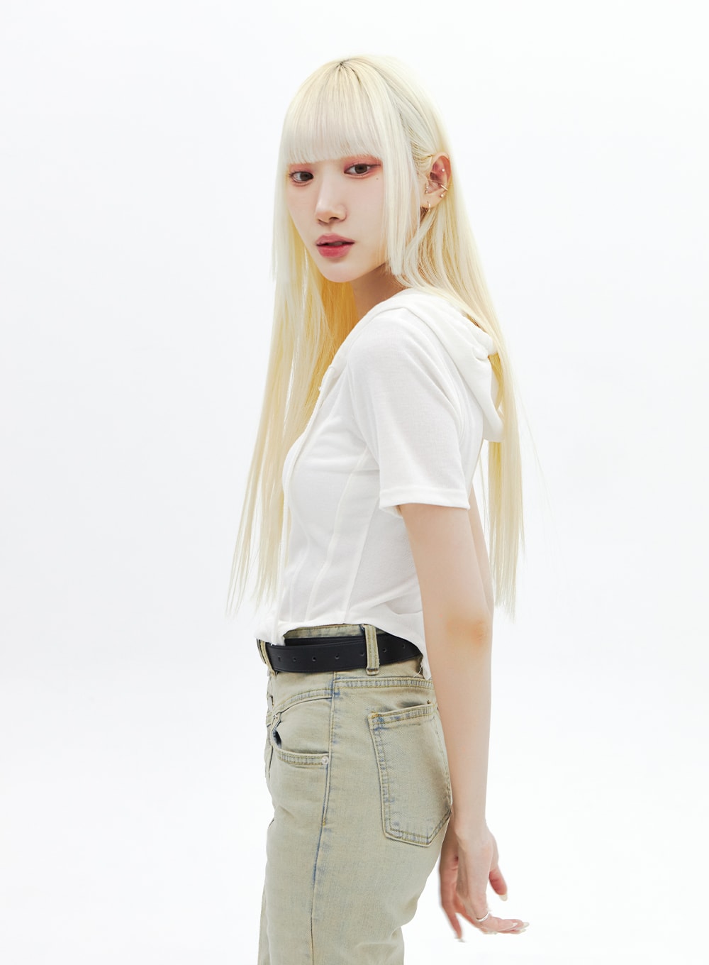 Beige Wash Bootcut Jeans BA320 in beige, upper hip close-up on model from side, showing high-rise waistband, back pocket, and washed cotton-spandex texture with black belt accent.