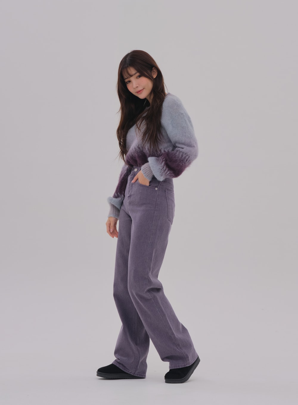 Wide Leg Color Jeans BS-A0812026 in purple, side-front angled view on model, hand in front pocket, high-waist wide-fit cotton denim, long length, paired with gradient fuzzy sweater and black shoes.