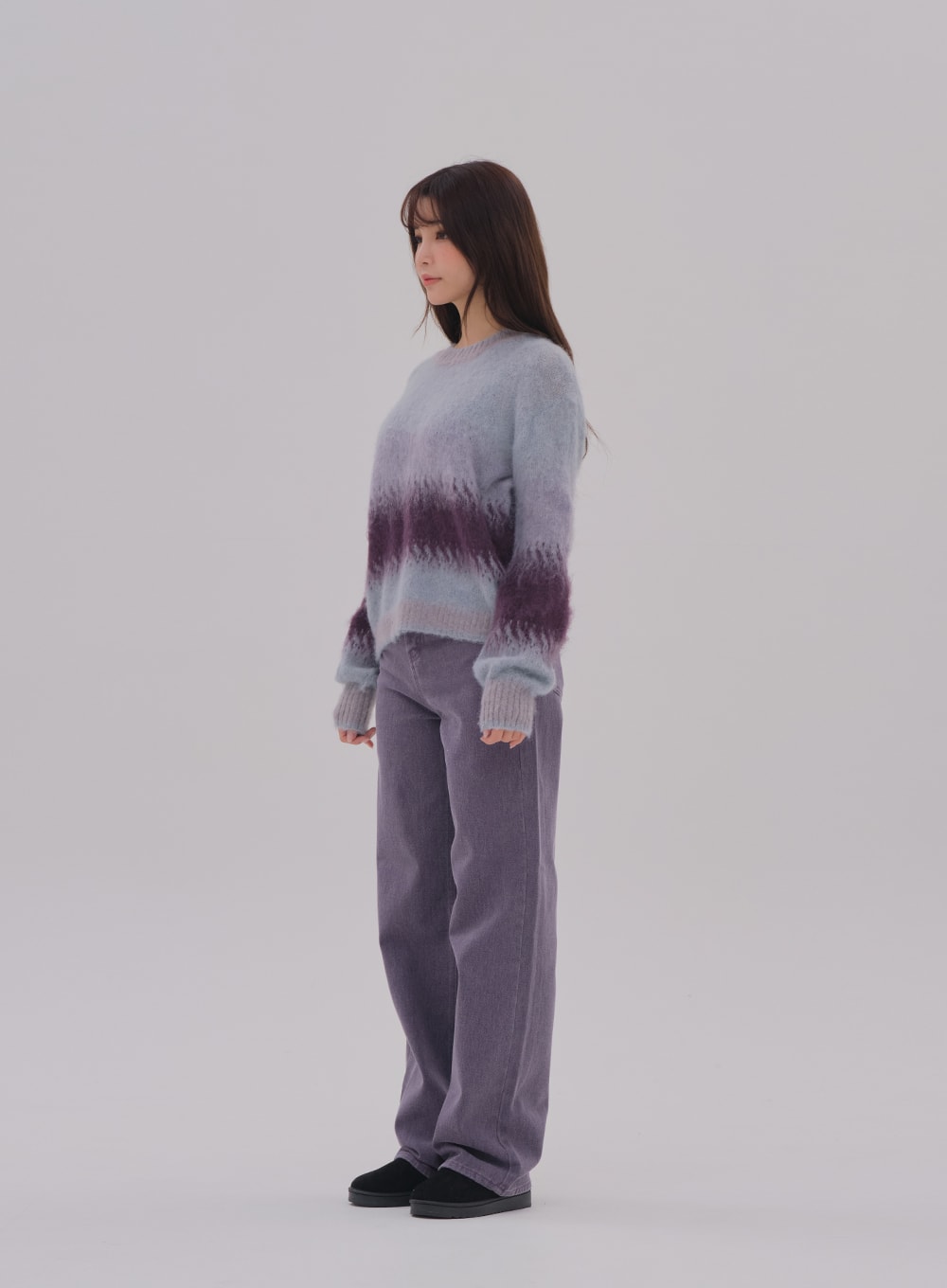 Wide Leg Color Jeans BS-A0812026 in purple, side full-length on model looking away, high-waist wide-fit cotton denim, long leg with slight flare at hem, styled with gradient knit top.