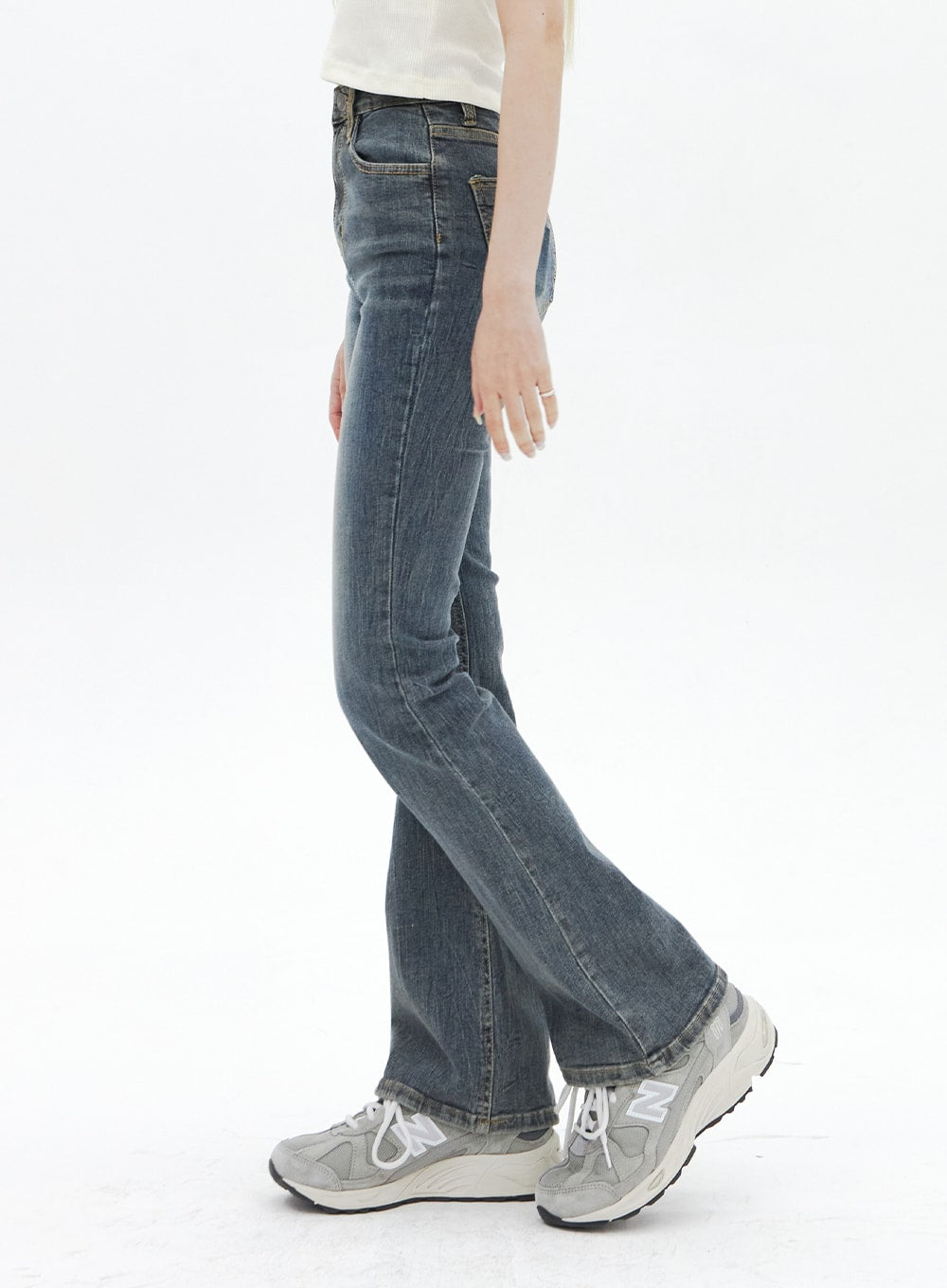 Dark Wash Bootcut Jeans BA320 in dark blue, side profile view on model, slim-fit through thigh flaring to bootcut hem, washed cotton-spandex denim with side seam detail.