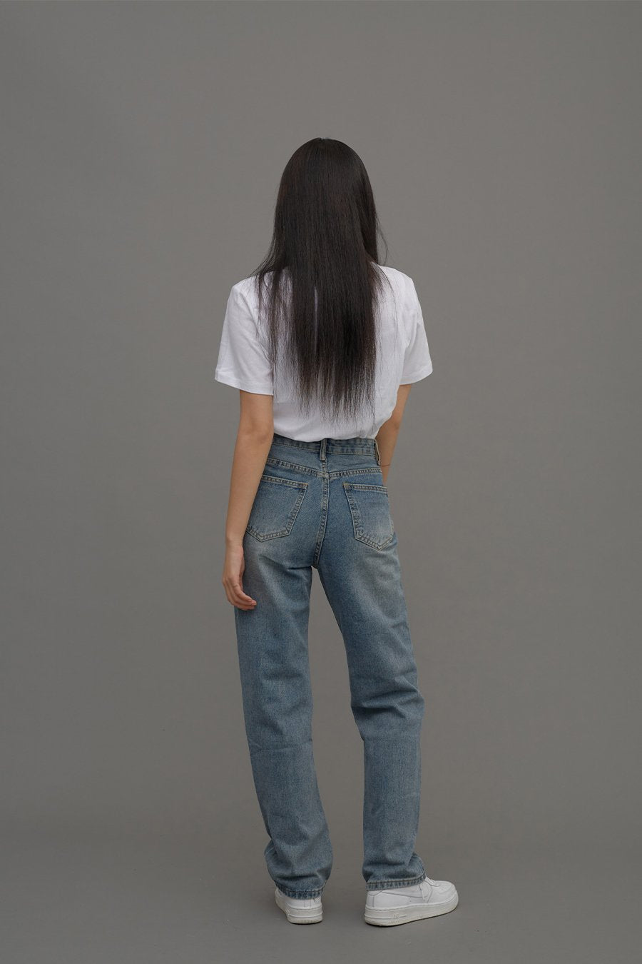 Straight Leg Jeans CM6 in Blue Denim, full-body back shot on model, back pockets and straight-leg silhouette fully visible, paired with white tee and white sneakers.