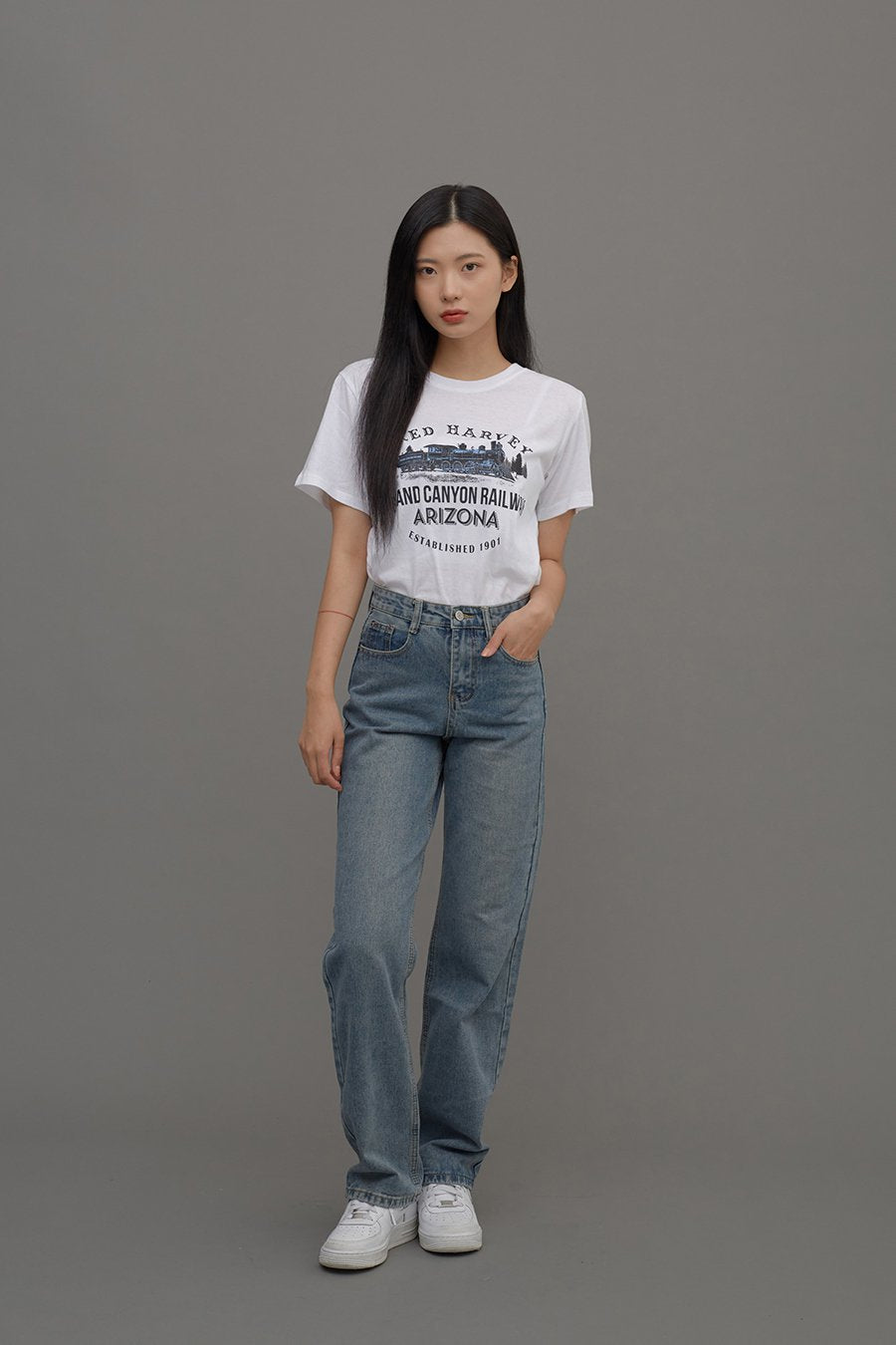 Straight Leg Jeans CM6 in Blue Denim, full-body front shot on model, arms at sides showing full length of cotton straight-leg silhouette, styled with white graphic tee and sneakers.