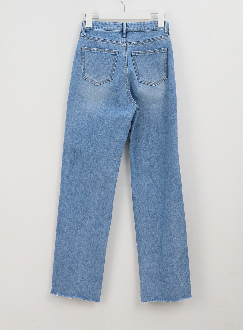 Light Wash Jeans OA310 in light blue, flat back hanger shot, wide-leg washed denim showing dual back pockets, waistband detail, and raw frayed hem with side slit.