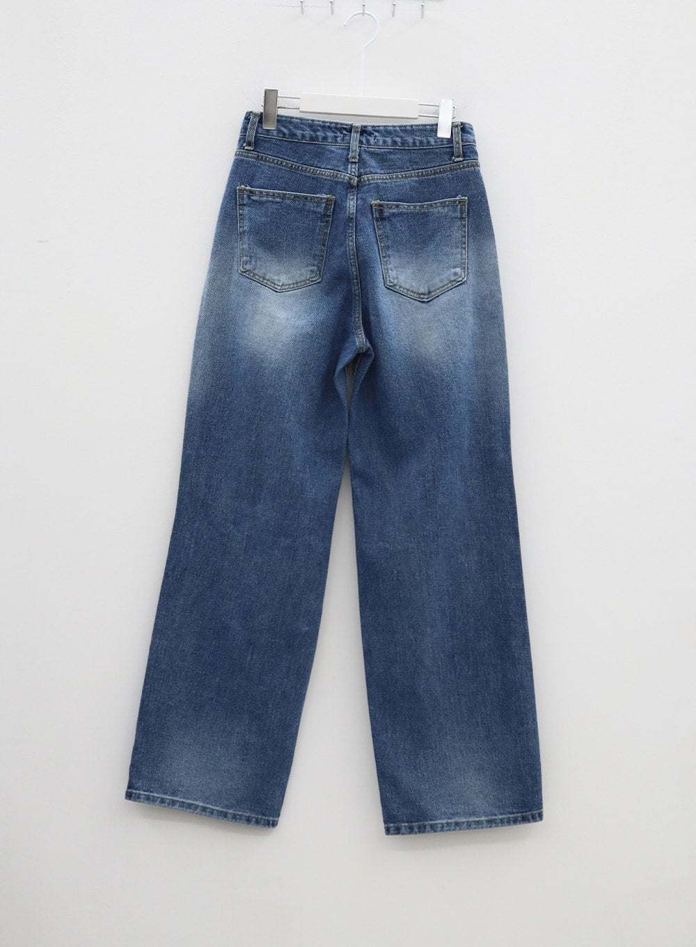 Ripped Knee Blue Jeans BA307 in blue, flat back hanger shot, wide-leg denim showing dual back pockets, faded whiskering at seat and thighs, clean straight hem.