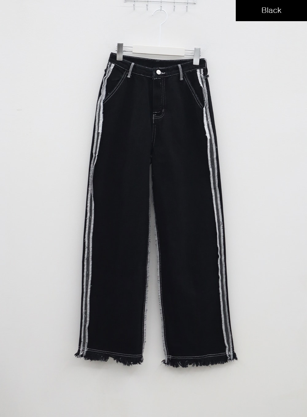 Stitch Detail Jeans BA307 in black, flat hanger front shot, wide-fit cotton denim with white contrast stitch side stripe, exposed raw seams, and raw fringe hem across the full leg length.